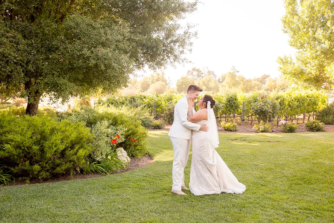 Brides kiss at Roblar Winery in Santa Ynez, CA