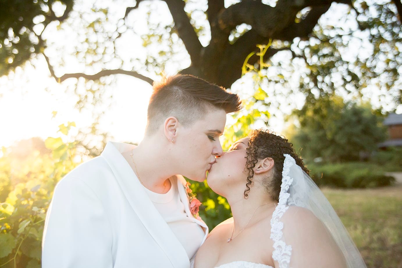 Brides kiss at sunset at Roblar Winery in Santa Ynez, CA 