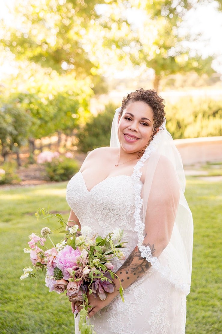 Bride poses on lawn at Roblar Winery in Santa Ynez, CA 