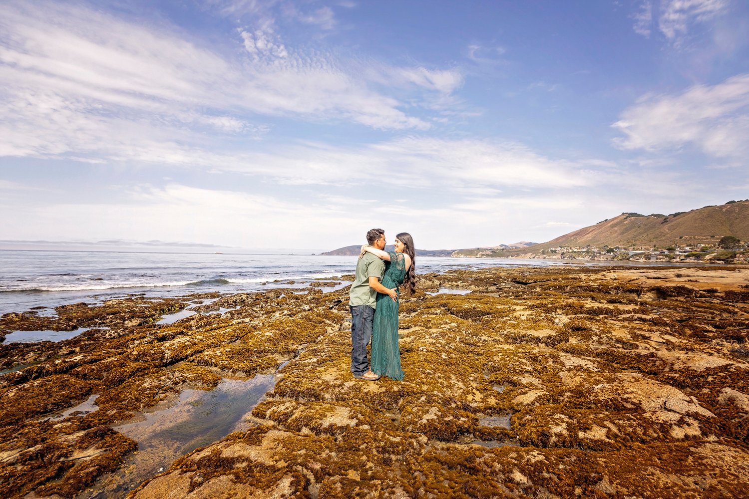 couple embracing at the beach during an engagement session